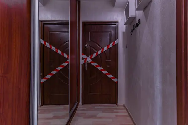 Stock image The entrance door to the apartment, police tape, secured the crime scene, burglary into the apartment