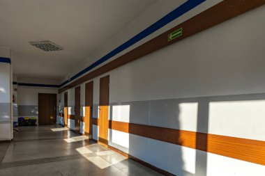 Waiting room in a hospital, medical clinic, empty chairs, empty seats, patients waiting to see a docto clipart