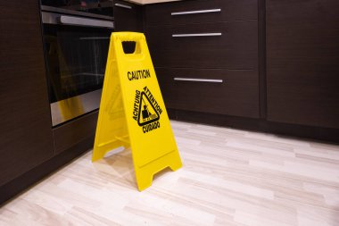 Warning for customers, slippery floor, yellow information board, attention: slippery floo clipart