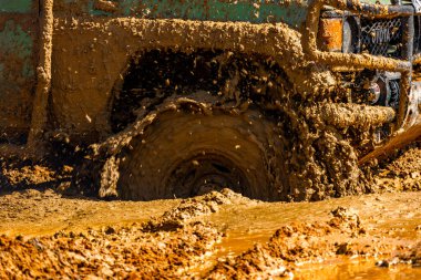 Çamur ve kumla kaplı arazi aracı lastikleri, su ve çamurla geçen araba, off-road aracı Towin.