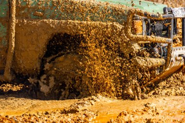 Çamur ve kumla kaplı arazi aracı lastikleri, su ve çamurla geçen araba, off-road aracı Towin.