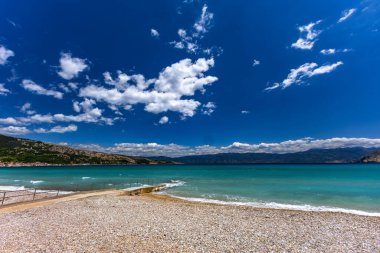 KRK adasındaki Baska 'daki boş çakıl taşı plajı, tatil sezonundan önce Hırvatistan' ın Adriyatik Denizi 'nde masmavi su