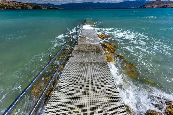 Plaj tekerlekli sandalyede hareket eden engelliler için uyarlandı, Adriyatik Denizi 'ne beton giriş engelliler için koruyucu bir parmaklık ile, 