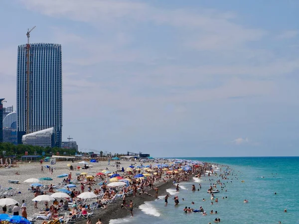 Arka planda ufuk çizgisi olan kalabalık bir Batumi plajı. Adjara, Georgia. Yüksek kalite fotoğraf