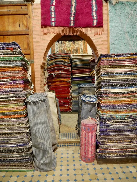 Pile of colorful Berber carpets in shop in Medina of Marrakech, Morocco. High quality photo