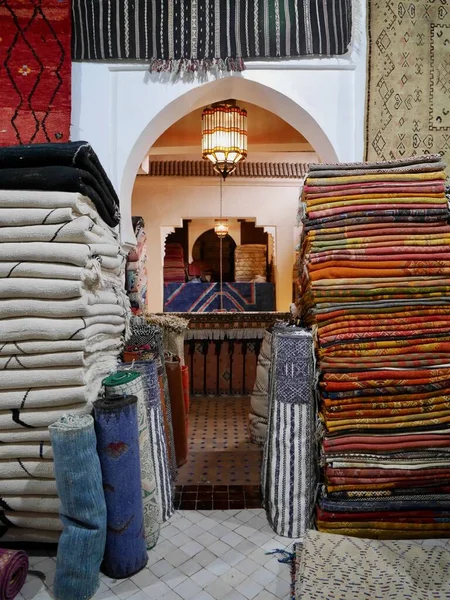 Pile of colorful Berber carpets in shop in Medina of Marrakech, Morocco. High quality photo