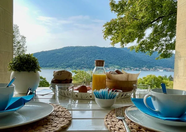 stock image Breakfast table overlooking Lago d'Iseo, Sarnico, Italy. High quality photo