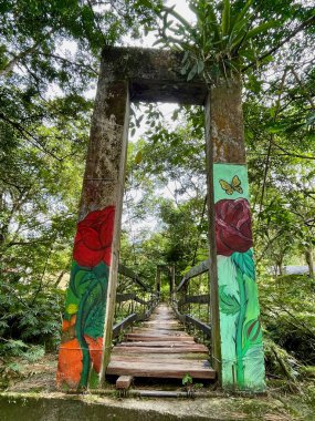 Colorful bridge spanning over Rio San Carlos in San Carlos, Antioquia, Colombia. High quality photo clipart