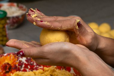 woman's hands with corn dough ball to prepare hallaca or tamale clipart