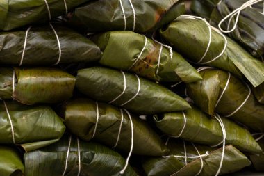 Hallaca or tamale wrapped in banana leaf. Traditional food clipart
