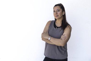 Portrait of confident entrepreneur mother standing with arms crossed against white background