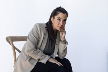 Portrait of confident entrepreneurial mother sitting looking at camera