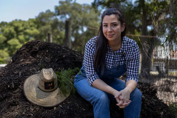 Portrait of sitting farmer woman with hat