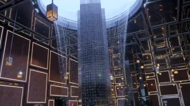 Modern şelale cam sütun yapısının etrafında çağlıyor.