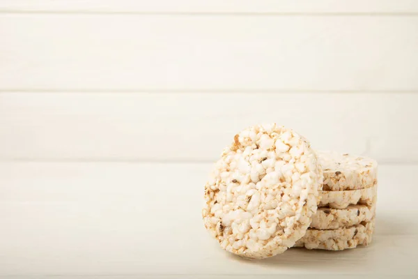 Round rice cakes on a white wooden table. Crispbread.Puffed rice bread. diet crispy round rice cakes.Place for text. Place for copy. Healthy food. dietary product.