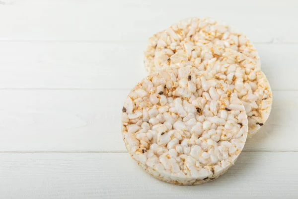 Round rice cakes on a white wooden table. Crispbread.Puffed rice bread. diet crispy round rice cakes.Place for text. Place for copy. Healthy food. dietary product.