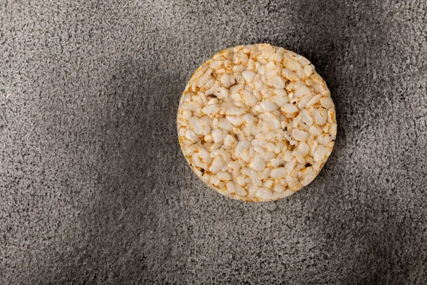 Round rice cakes on a  black table. Crispbread.Puffed rice bread. diet crispy round rice cakes.Place for text. Place for copy. Healthy food. dietary product.