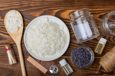 Ekolojik ve vejetaryen el yapımı soya mumu ve ahşap fitil. Şeffaf konteynır, temel yağ, soya cilası, kibrit ve kurumuş çiçekler. MOCKUP, mesaj için alan. El yapımı el yapımı mumlar..