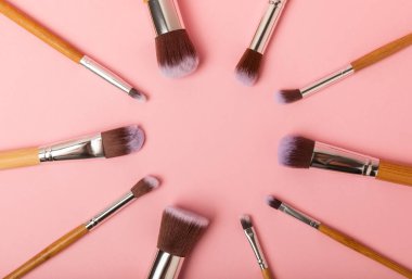 Pembe arka planda kozmetik makyaj fırçası. Makyaj için kozmetik ürün. Yaratıcı ve güzel moda konsepti. Moda. Kozmetik makyaj fırçası koleksiyonu, üst görüş, afiş. Mesaj için yer. MOCAP.