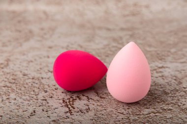 Kahverengi mermer arka planda güzellik blenderi. Makyaj süngeri. Güzellik konsepti. Vakıf, pansiyon kremi ya da uyku kapağı için sünger. Mesaj için yer. Boşluğu kopyala.