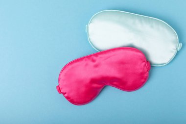 Mavi bir arka planda uyku maskesi. Güzel manzara. FLETLEY. Dinlendirici ve sağlam uyku kavramı.