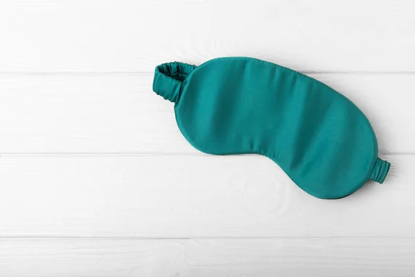 Sleep mask on a white textured background.Top view.FLETLEY. The concept of restful and sound sleep.