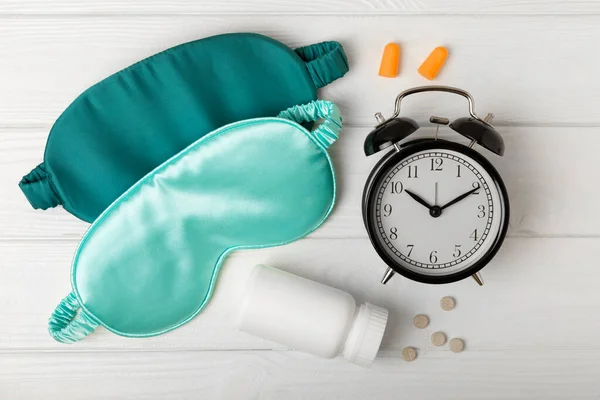Sleep Mask Alarm Clock Earplugs Sleeping Pills White Texture Background — Stock Photo, Image