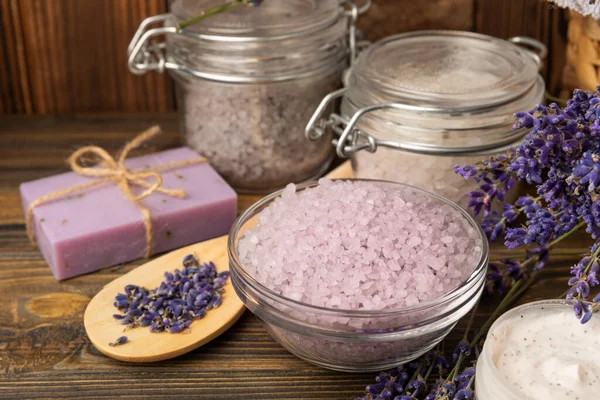 spa lavender. Sea salt, body cream and handmade soap on a brown textural background. Natural cosmetics on herbs with lavender flowers. Relak and relaxation. Aromatherapy. beauty concept