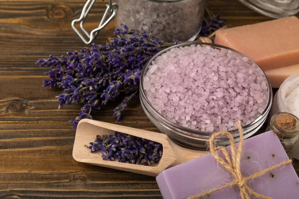 spa lavender. Sea salt, body cream and handmade soap on a brown textural background. Natural cosmetics on herbs with lavender flowers. Relak and relaxation. Aromatherapy. beauty concept