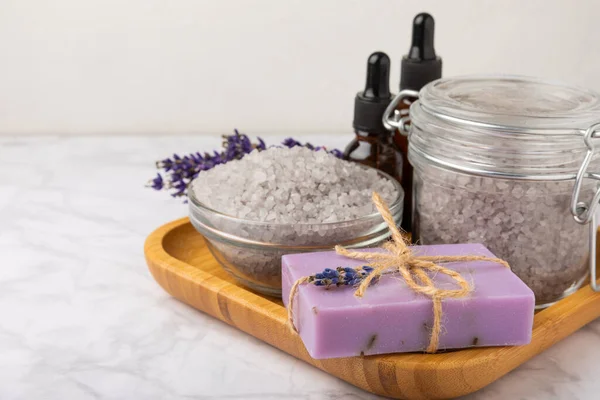 spa lavender. Sea salt, essential oils and handmade soap on a white marble background. Natural cosmetics on herbs with lavender flowers. Relak and relaxation. Aromatherapy. beauty concept