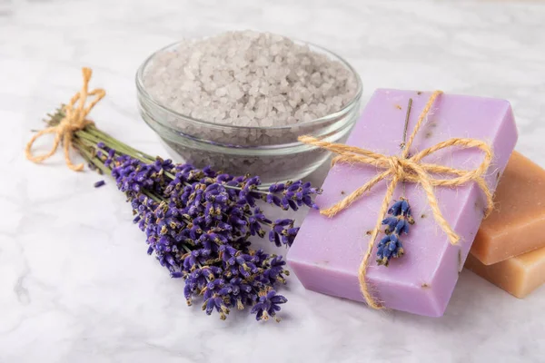 spa lavender. Sea salt and handmade soap on a white marble background. Natural cosmetics on herbs with lavender flowers. Relak and relaxation. Aromatherapy. beauty concept