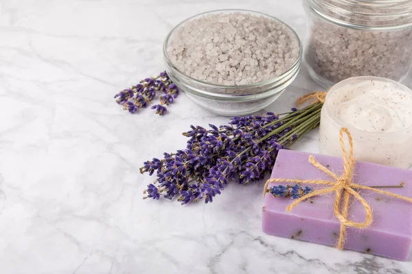 spa lavender. Sea salt, body cream and handmade soap on a white marble background. Natural cosmetics on herbs with lavender flowers. Relak and relaxation. Aromatherapy. beauty concept