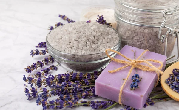 spa lavender. Sea salt, body cream and handmade soap on a white marble background. Natural cosmetics on herbs with lavender flowers. Relak and relaxation. Aromatherapy. beauty concept