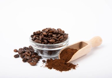 Ground coffee and beans in a bowl and loose isolated on a white background.