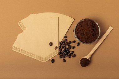 Background with coffee, coffee beans, ground and instant, coffee filter on brown retro background. Copy space, top view. Flat lay