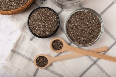 Chia seeds in a bowl and spoons on white marble. Superfood. Antioxidant. Healthy food. Proper nutrition. Diet concept. Place for text. Place to copy.