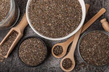 Chia seeds in a bowl and spoons on black marble. Superfood. Antioxidant. Healthy food. Proper nutrition. Diet concept. Place for text. Place to copy.