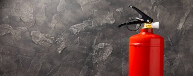 Fire extinguisher on a black marble background. Fire protection, home fire extinguisher. home security concept. Place for text. Copy space.