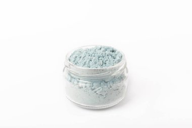 Blue spirulina powder in glass jar isolated on white background. Natural vegan superfood. Food supplement. Phycocyanin extract.