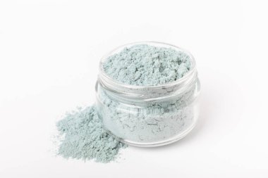Blue spirulina powder in glass jar isolated on white background. Natural vegan superfood. Food supplement. Phycocyanin extract.