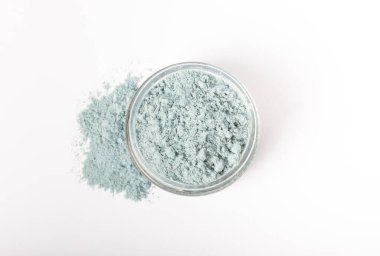Blue spirulina powder in glass jar isolated on white background. Natural vegan superfood. Food supplement. Phycocyanin extract.
