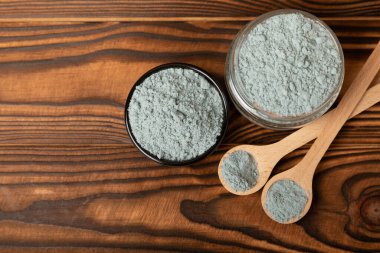 Blue Spirulina algae powder on brown texture background. Diet and detox concept.Natural vegan superfood. Food supplement. Copy space. Place for text.