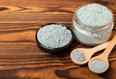 Blue Spirulina algae powder on brown texture background. Diet and detox concept.Natural vegan superfood. Food supplement. Copy space. Place for text.