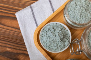 Blue Spirulina algae powder on brown texture background. Diet and detox concept.Natural vegan superfood. Food supplement. Copy space. Place for text.