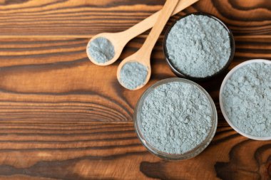 Blue Spirulina algae powder on brown texture background. Diet and detox concept.Natural vegan superfood. Food supplement. Copy space. Place for text.