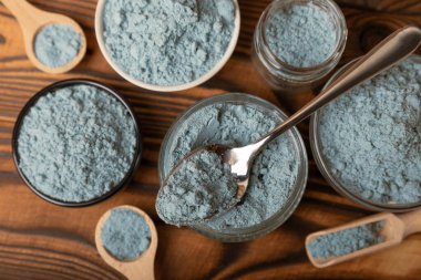 Blue Spirulina algae powder on brown texture background. Diet and detox concept.Natural vegan superfood. Food supplement. Copy space. Place for text.