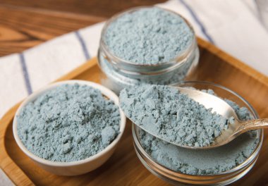 Blue Spirulina algae powder on brown texture background. Diet and detox concept.Natural vegan superfood. Food supplement. Copy space. Place for text.