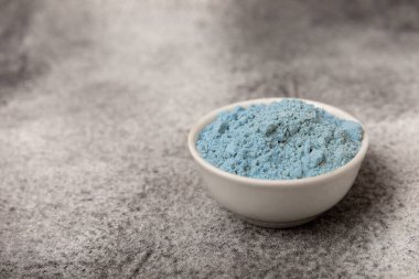 Blue Spirulina algae powder on black marble background. Diet and detox concept.Natural vegan superfood. Food supplement. Copy space. Place for text.