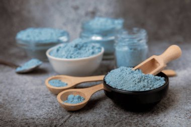 Blue Spirulina algae powder on black marble background. Diet and detox concept.Natural vegan superfood. Food supplement. Copy space. Place for text.