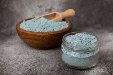 Blue Spirulina algae powder on black marble background. Diet and detox concept.Natural vegan superfood. Food supplement. Copy space. Place for text.